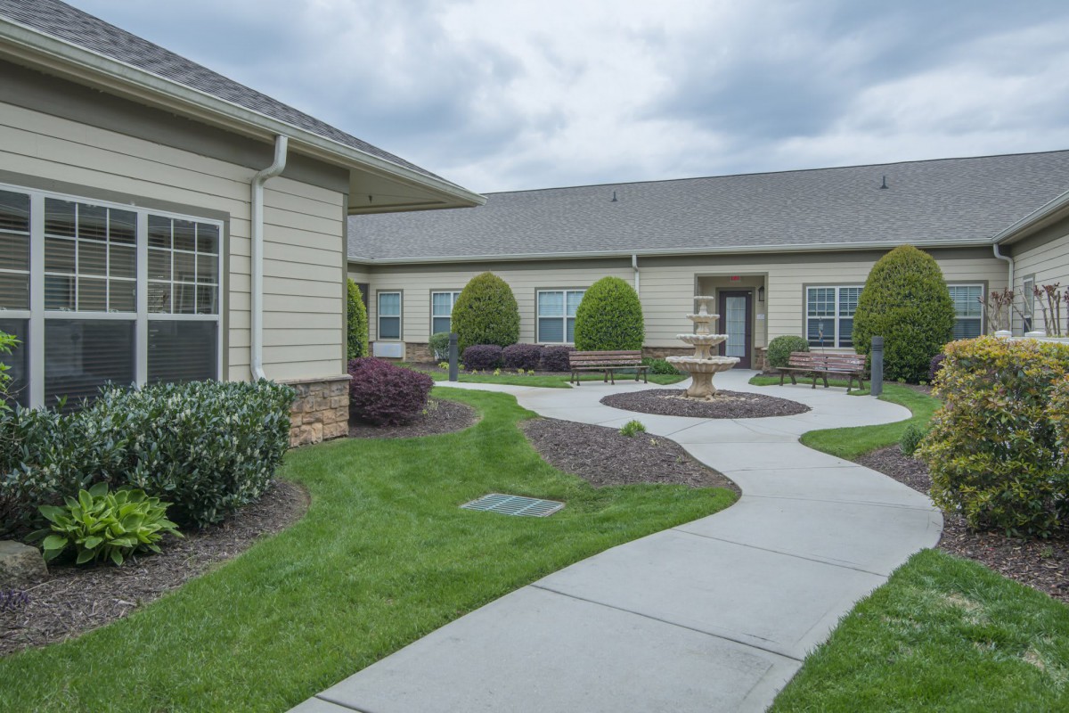 A residential area featuring a well-maintained garden and pathway.