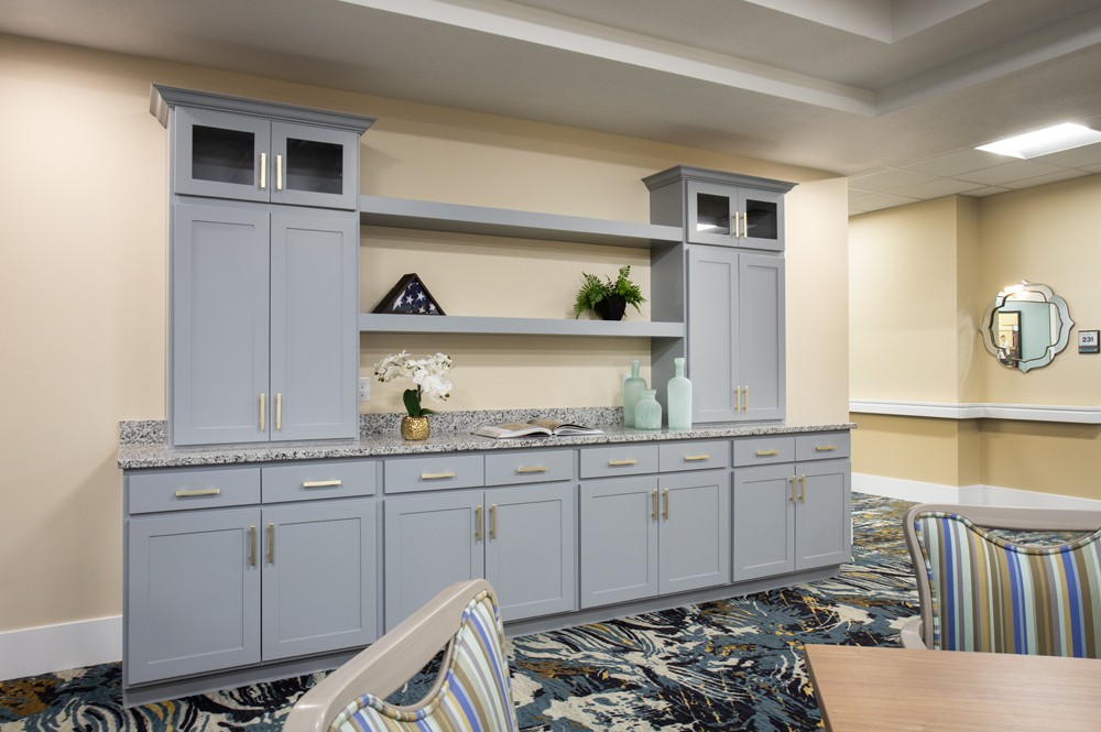A modern interior space featuring stylish cabinetry and open shelving.