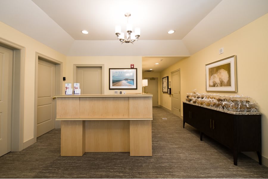 A well-lit reception area with a front desk and decorative elements.