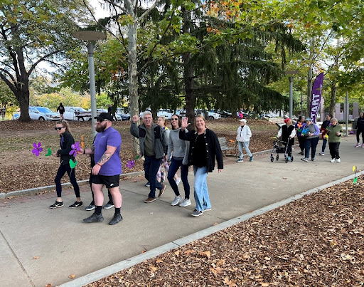 Participants walking together in a community event surrounded by nature.