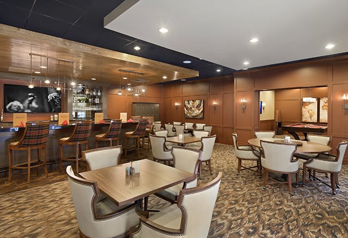A cozy restaurant interior with a bar and seating area.