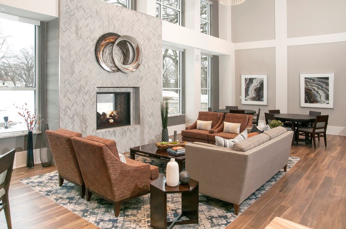 A modern living room featuring a fireplace, stylish furniture, and elegant decor.