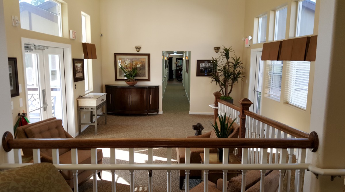 A well-decorated hallway with artwork and plants.