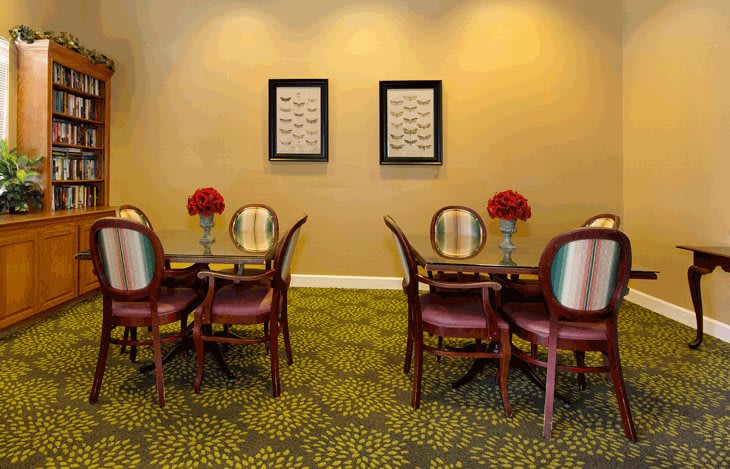 A cozy dining area with elegant seating and artistic decor.