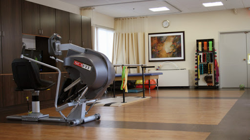 A well-equipped rehabilitation therapy room featuring modern exercise equipment and a calming atmosphere.