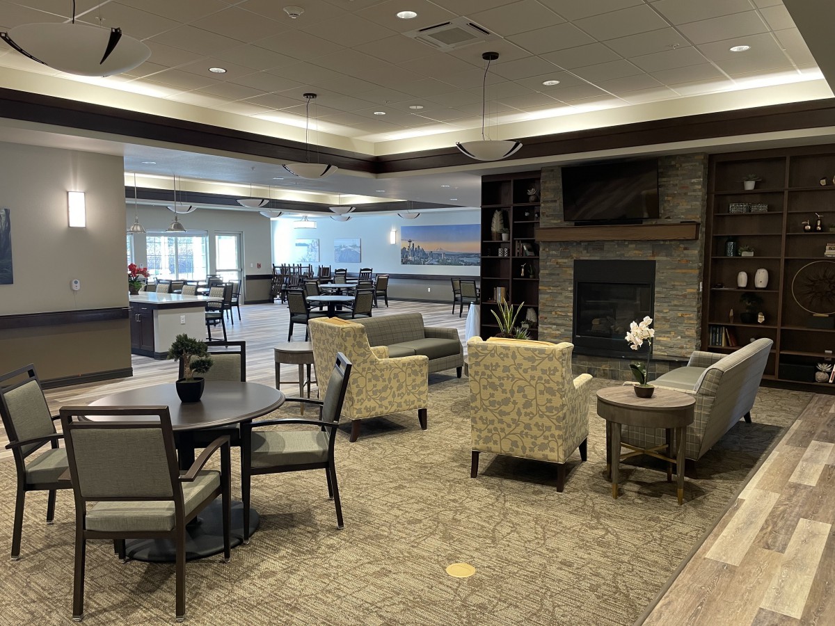 A modern lounge area featuring comfortable seating and a fireplace.