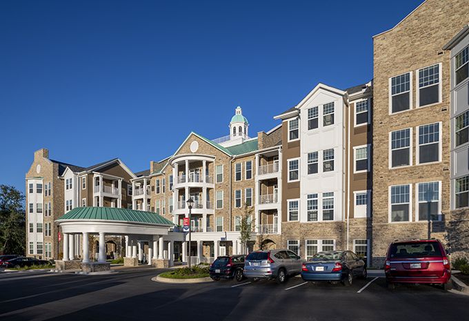 Exterior view of a residential apartment complex with parked cars.