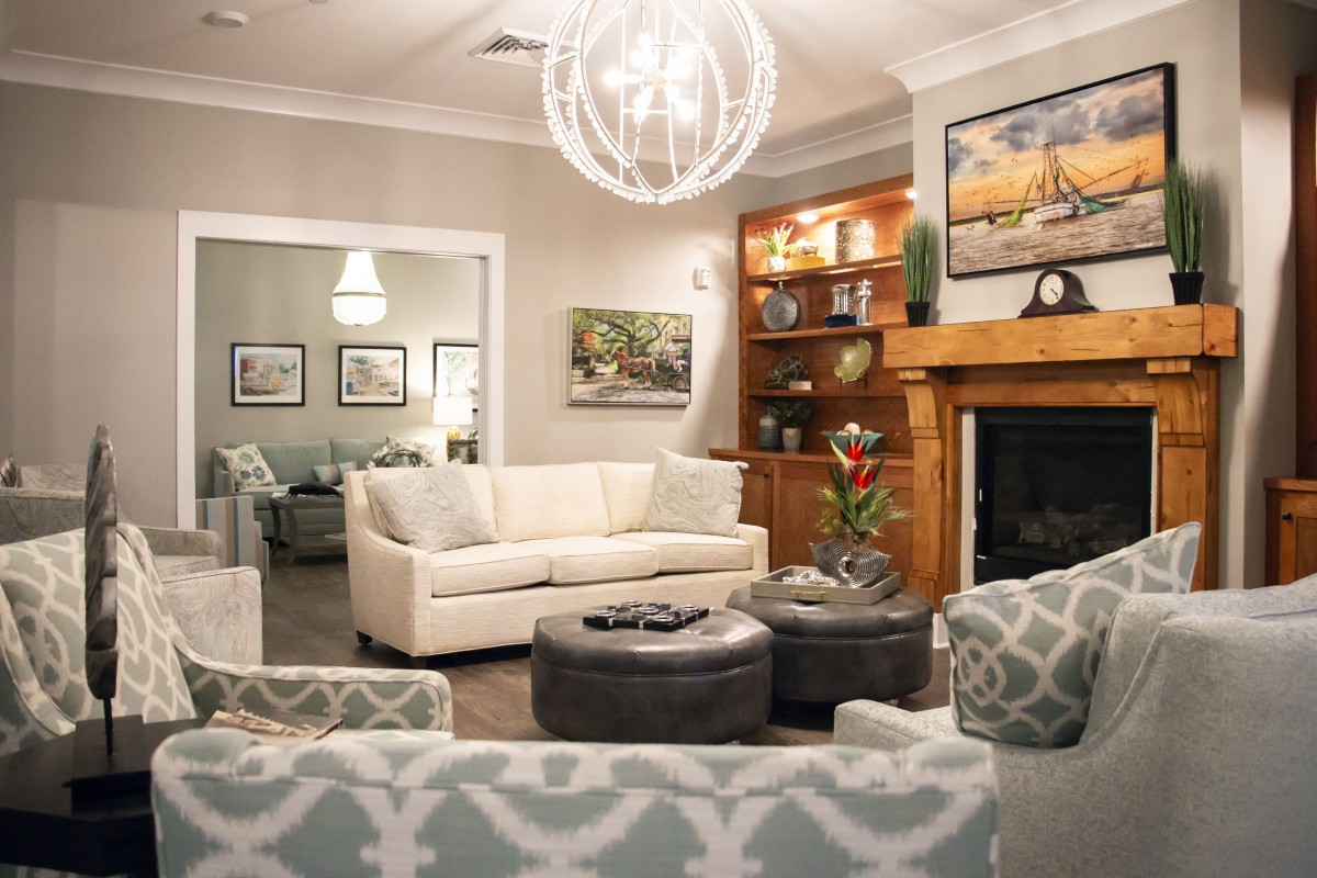 A stylish living room featuring a modern design with comfortable seating, warm lighting, and elegant decor.