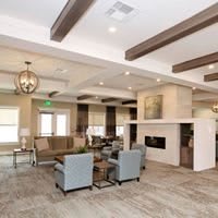 A modern living room with stylish furniture and a fireplace.