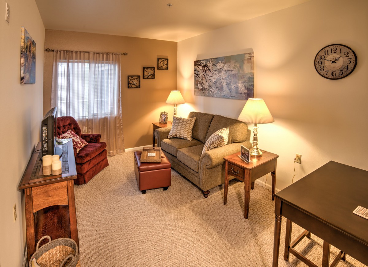 A cozy living room with warm lighting and comfortable seating.