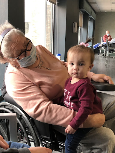 A heartwarming moment between an elderly woman and a young child, sharing a tender connection.