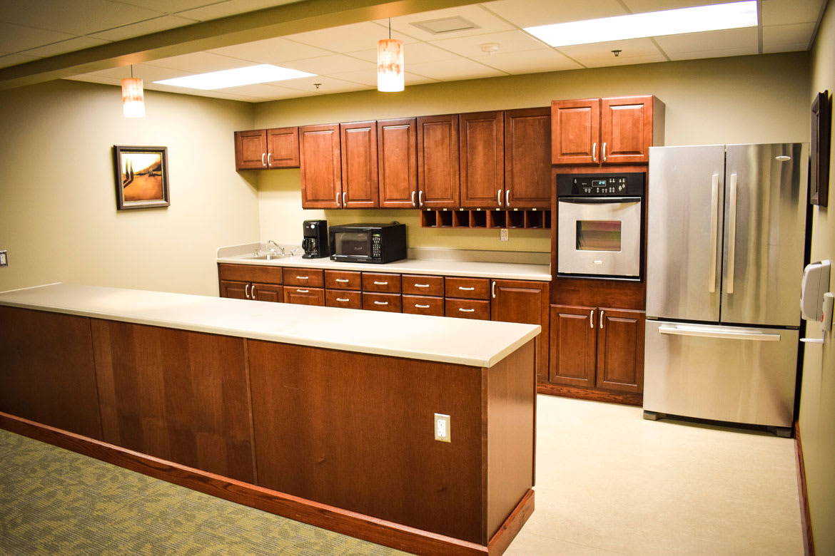 A modern kitchen with wooden cabinets and built-in appliances.
