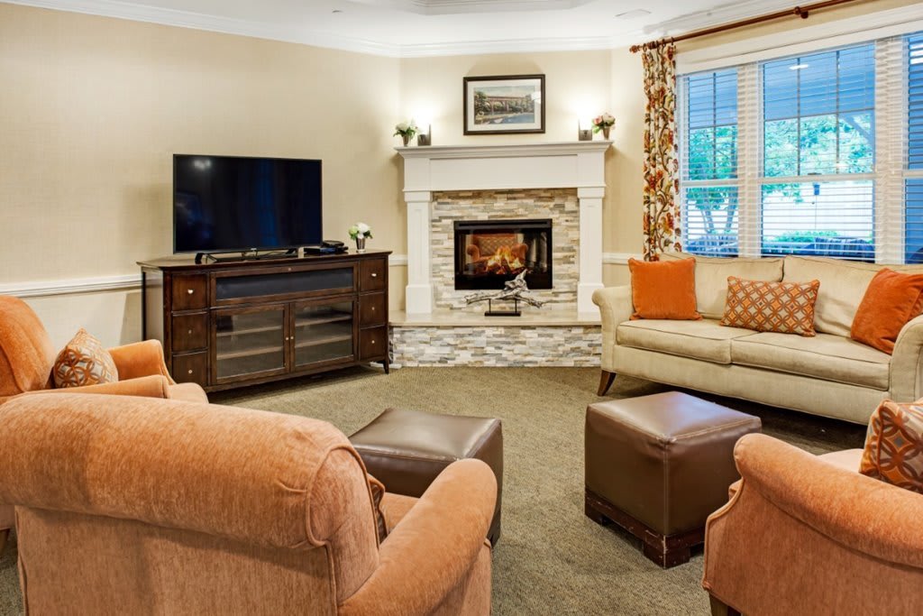 A cozy living room featuring a fireplace and comfortable seating.