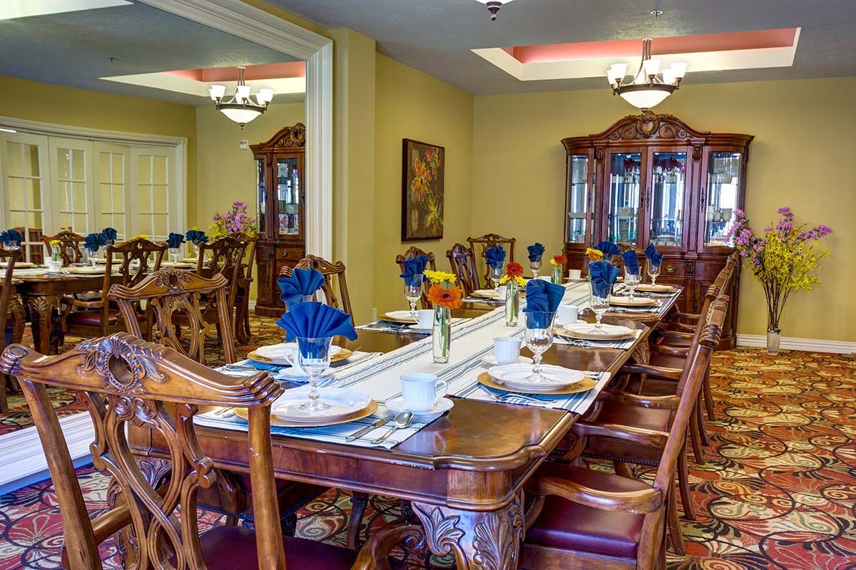 A beautifully set formal dining room with elegant wooden furniture and decorative napkins.