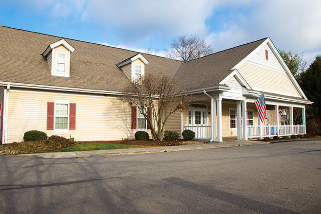 A suburban-style building with a driveway and an American flag displayed.