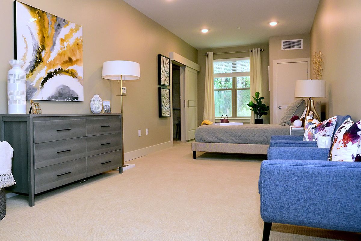A modern bedroom with stylish furnishings and a cozy atmosphere.