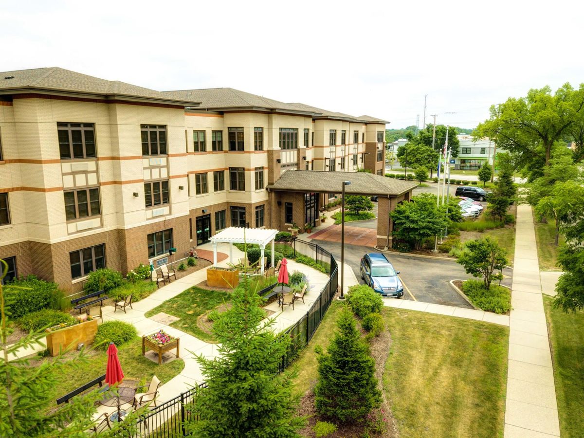 A modern residential building with a landscaped garden area.