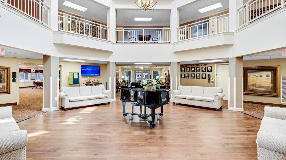 A spacious and elegantly designed lobby area with comfortable seating and a central display.