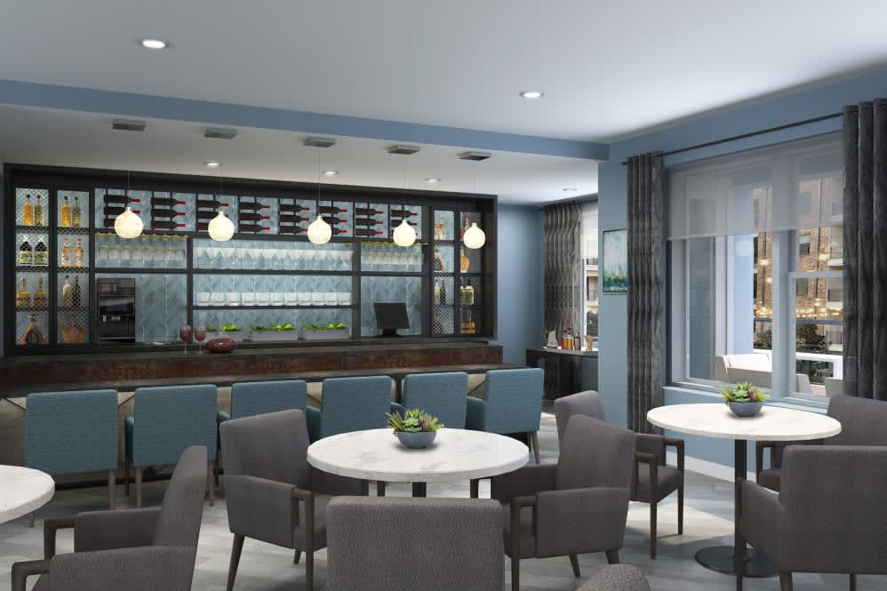 A modern restaurant interior featuring a bar and seating area with contemporary furniture.