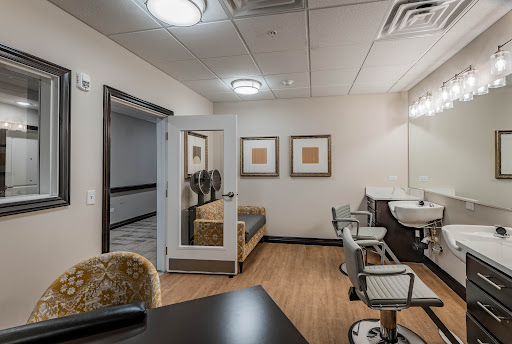 A modern and stylish interior of a salon, featuring hair styling stations and a cozy waiting area.