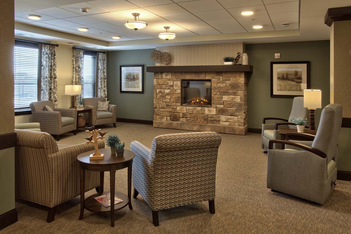 A cozy living room with comfortable seating and a warm fireplace.