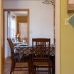 A cozy dining area with a wooden table and chairs, featuring natural light from a nearby window.