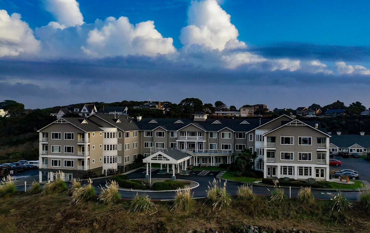 A scenic view of a large residential complex under a cloudy sky.