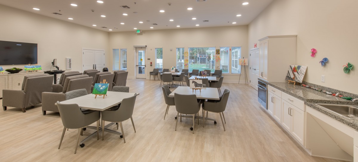 A spacious, modern dining area with tables and chairs set up for communal use.
