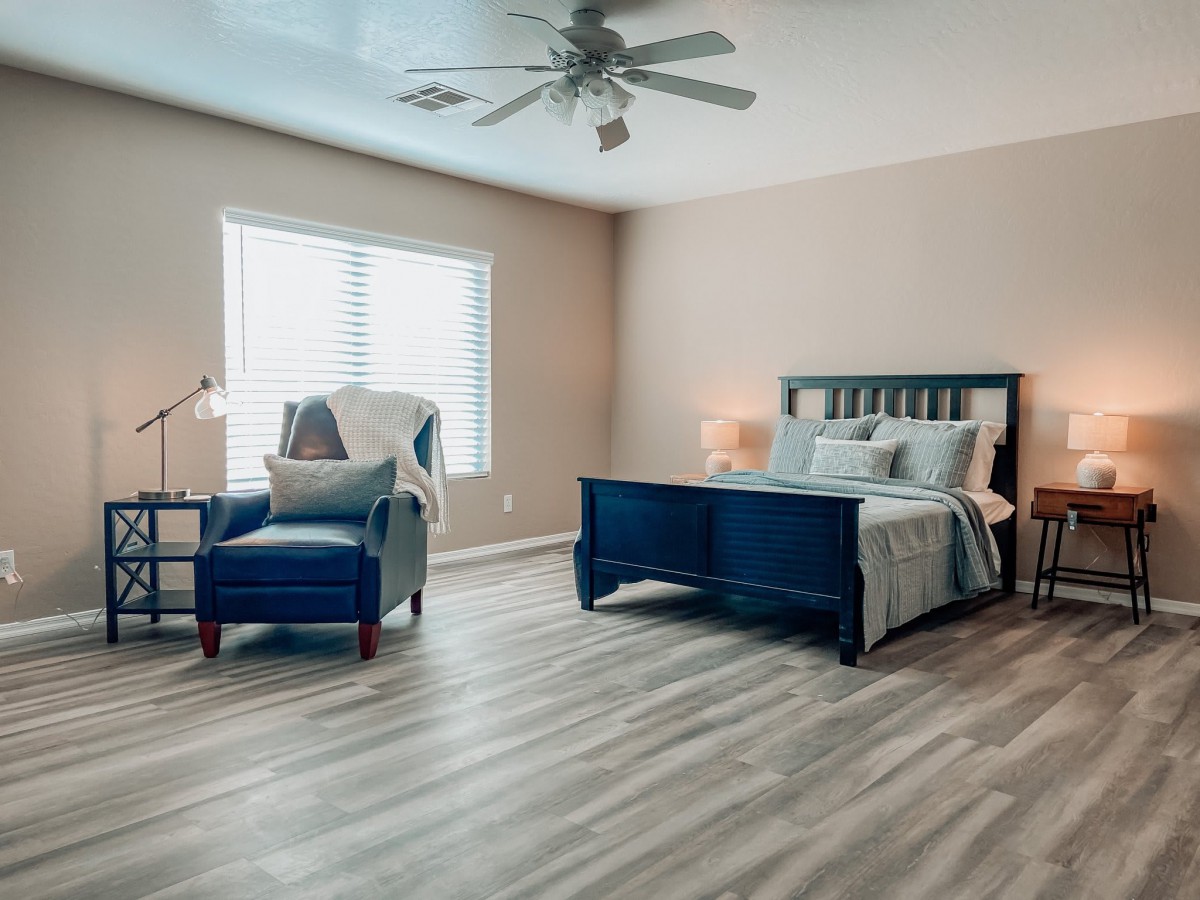 A spacious and modern bedroom with a comfortable bed and stylish furnishings.