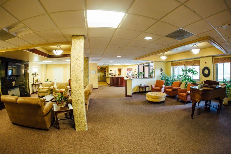 A spacious lobby featuring comfortable seating and warm lighting.