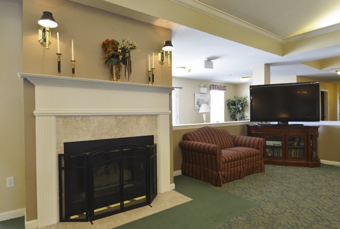 A cozy living room with a fireplace and comfortable seating area.