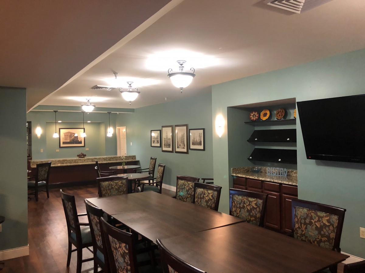 A modern dining or meeting area with a large table, stylish chairs, and ambient lighting.