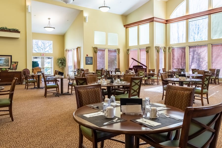 An elegant and spacious dining area with neatly arranged tables and large windows.