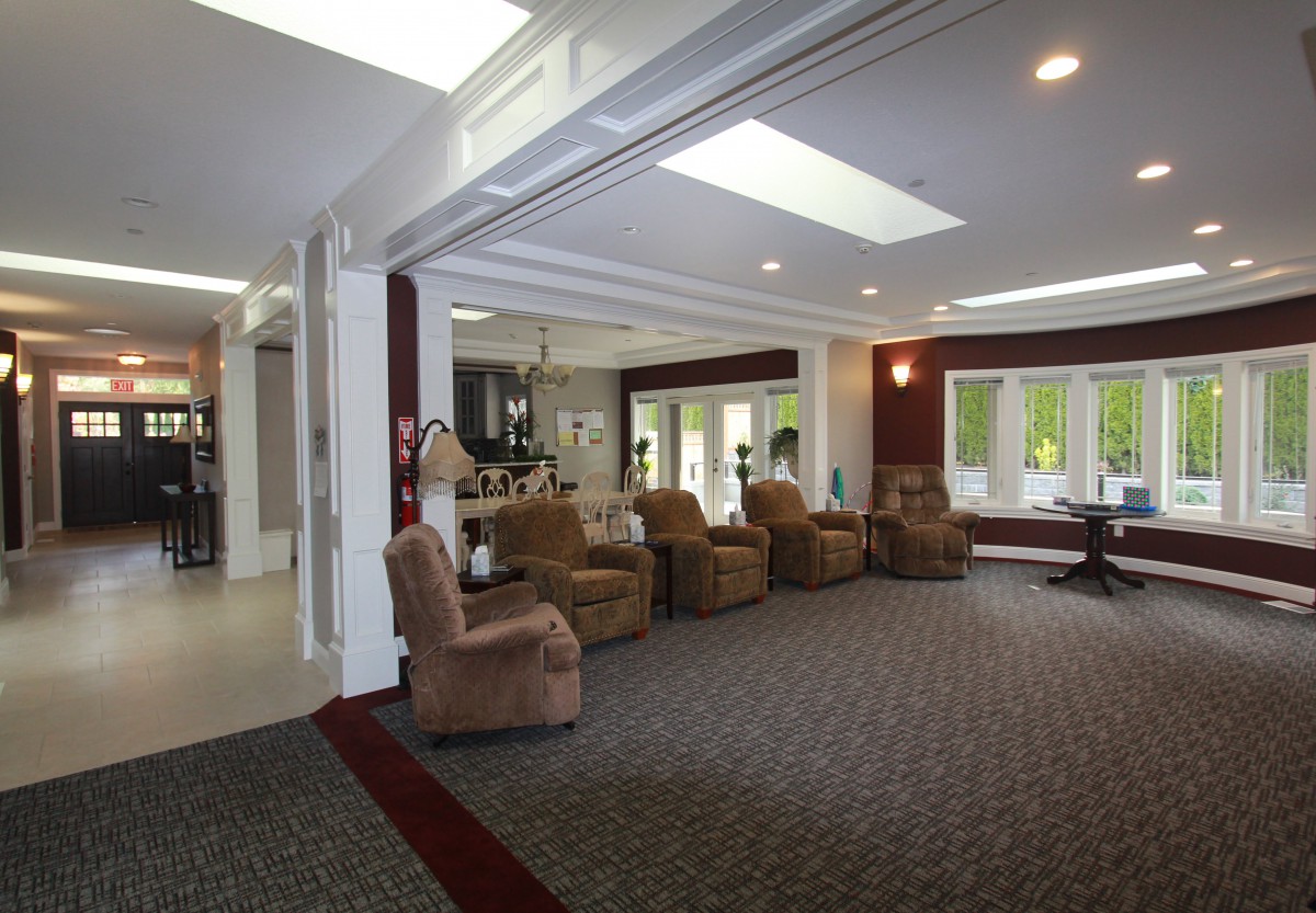 A spacious living room with comfortable seating and natural lighting.