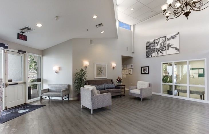 A modern and spacious lobby featuring comfortable seating and decorative artwork.