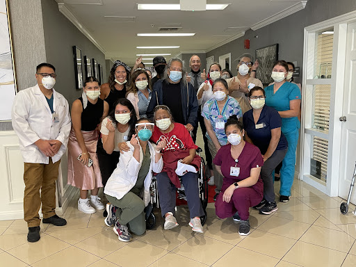 A joyful gathering of healthcare workers and patients, showcasing the spirit of care and community in a medical facility.