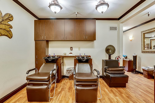A cozy hair salon featuring styling chairs and a warm interior atmosphere.