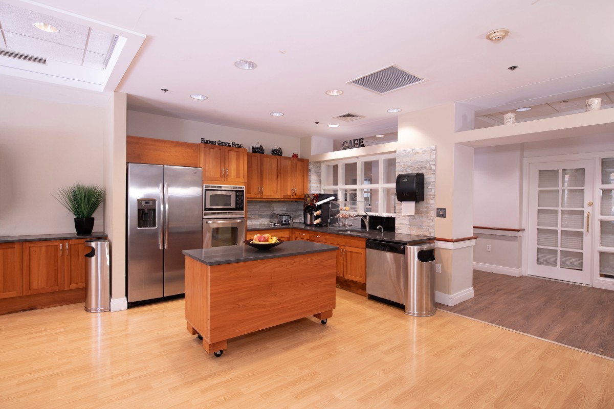 A modern kitchen with stainless steel appliances and a central island.