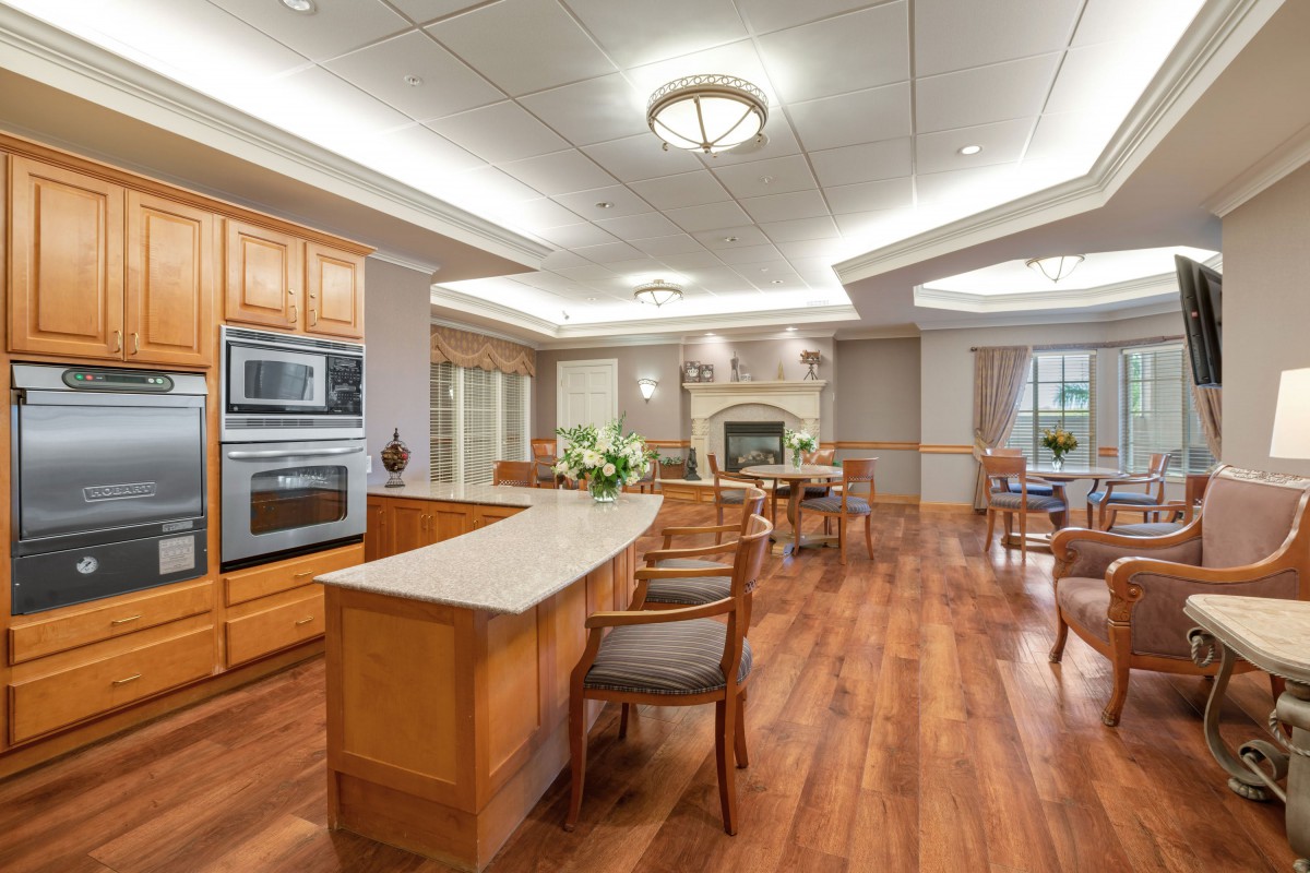 A spacious kitchen and dining area with hardwood floors and bright lighting.