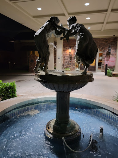 A beautifully illuminated fountain featuring two figures at night.