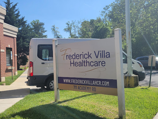 Sign for Frederick Villa Healthcare, featuring a vehicle parked nearby.