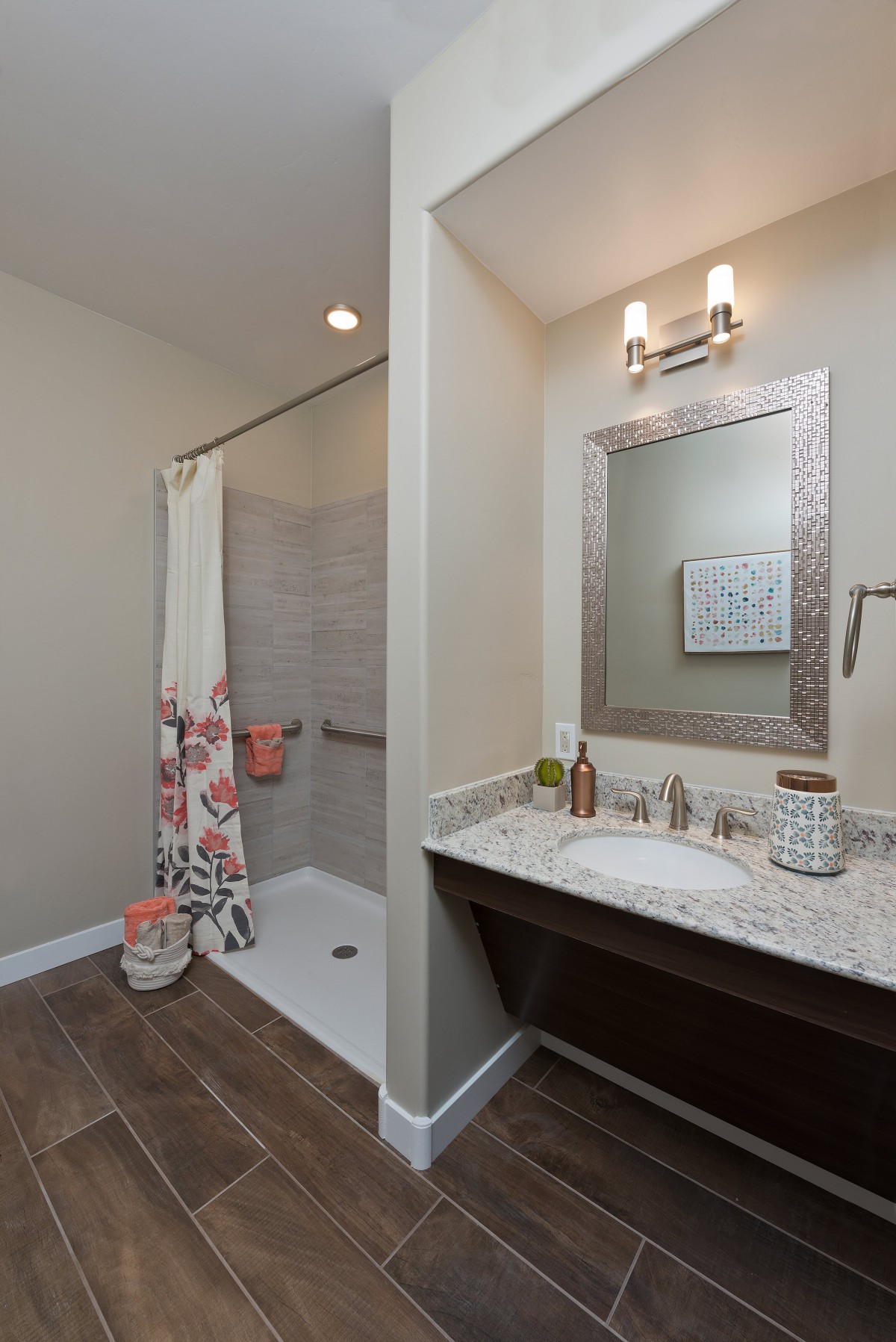 A modern bathroom with a shower area and well-lit vanity.