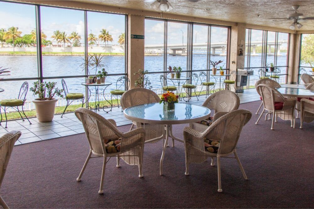 A cozy seating area with a scenic view of the water through large glass windows.