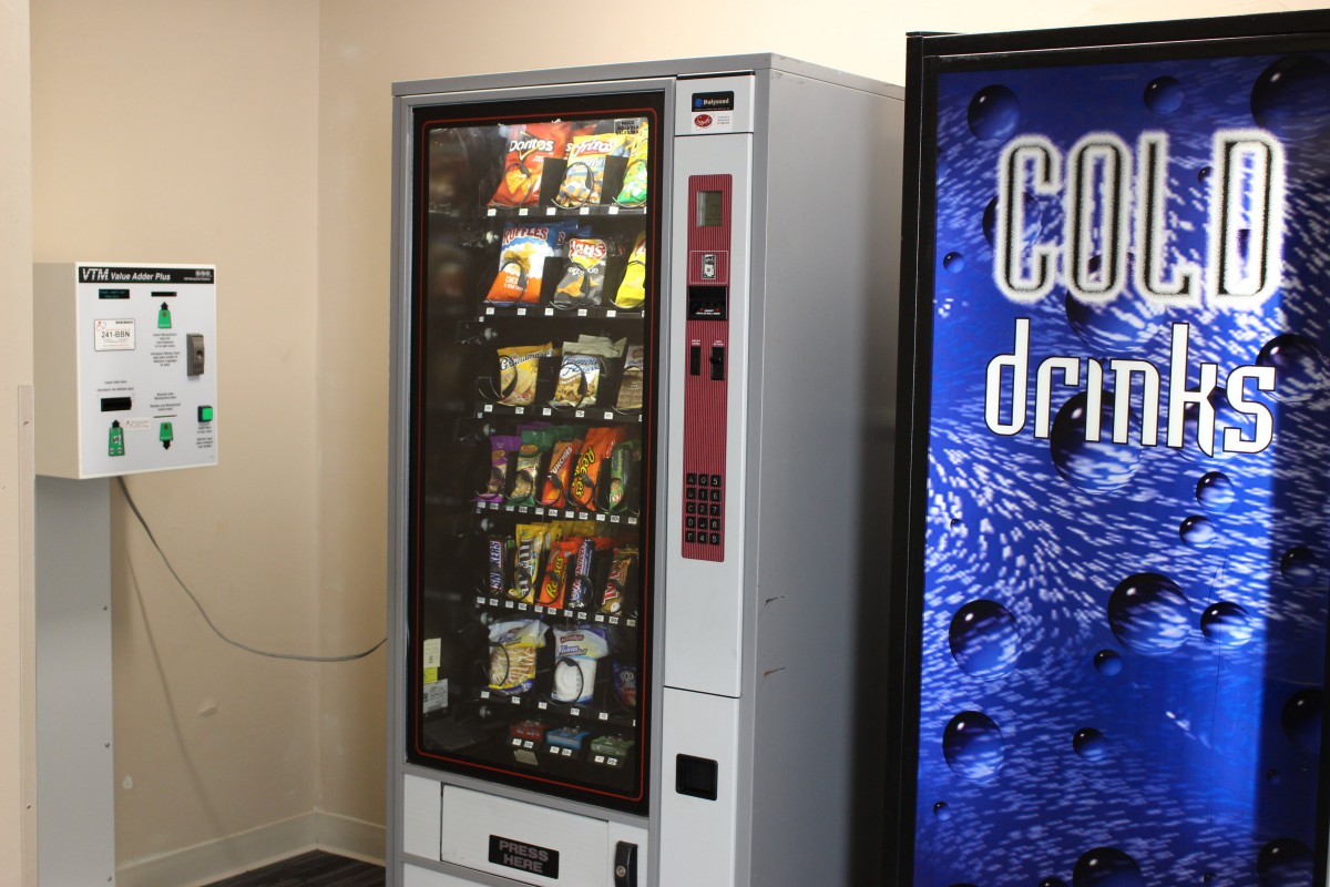 A vending machine offering snacks and drinks indoors.
