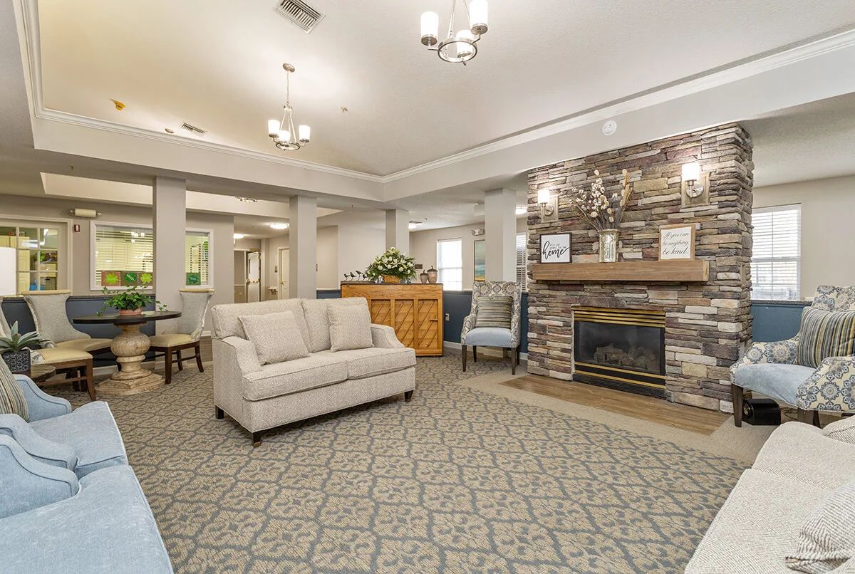 A cozy living room featuring a comfortable sofa and a stone fireplace.