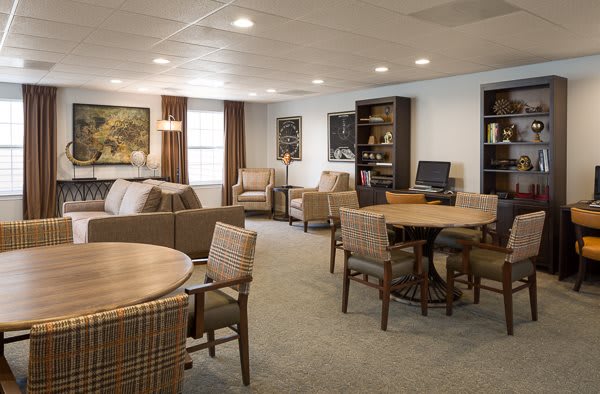 A cozy living room with comfortable seating and tables.