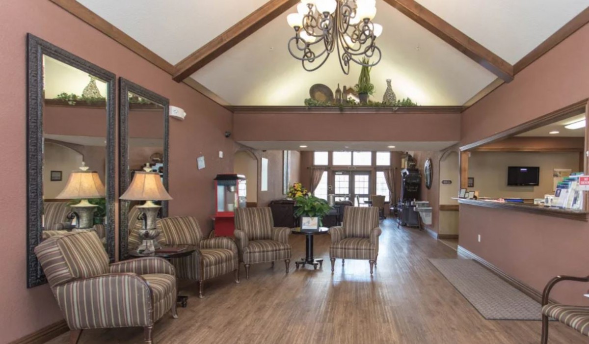 A spacious lobby with elegant chandeliers, comfortable seating, and tasteful decor.