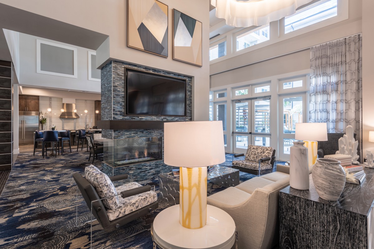 A modern living room with stylish furniture and large windows.
