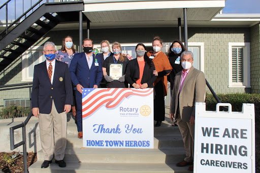 Community members gather to honor local heroes at a Rotary Club event, showing appreciation with a special recognition.