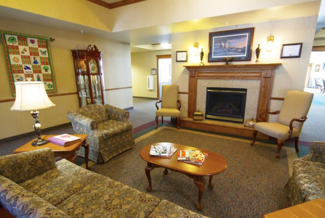 A cozy living room with comfortable seating and a fireplace.